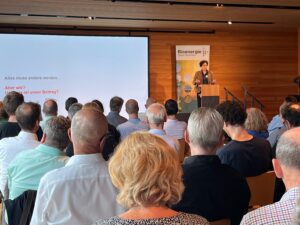 Prof. Dr. Maike Sippel steht am Rednerpult vor rund 200 Gästen in einem Konferenzraum.